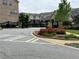 Gated community entrance with black wrought iron gates surrounded by vibrant landscaping and lush greenery on a well-maintained street at 2251 Nancy Creek Dr, Atlanta, GA 30341