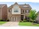 Charming two-story brick home boasts a two-car garage, manicured lawn, and inviting curb appeal at 2251 Nancy Creek Dr, Atlanta, GA 30341