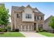 Inviting two-story brick home with a well-kept lawn, two-car garage, and appealing architectural details at 2251 Nancy Creek Dr, Atlanta, GA 30341
