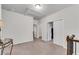 Upstairs hallway featuring multiple entry doors, neutral carpeting, and a decorative table at 2251 Nancy Creek Dr, Atlanta, GA 30341