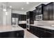 Gourmet kitchen featuring a large island, granite counters, stainless steel appliances and dark wood cabinets at 2251 Nancy Creek Dr, Atlanta, GA 30341