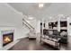 Open-concept living room with fireplace, hardwood floors, and view of the modern kitchen at 2251 Nancy Creek Dr, Atlanta, GA 30341