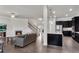 Spacious living area with open floor plan showcasing fireplace, kitchen island and staircase at 2251 Nancy Creek Dr, Atlanta, GA 30341
