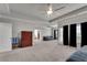 Expansive main bedroom boasts a ceiling fan, black curtains, and ample space for seating at 2251 Nancy Creek Dr, Atlanta, GA 30341