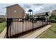 Community playground featuring a slide and climbing structure is surrounded by a safety fence and manicured lawn at 2251 Nancy Creek Dr, Atlanta, GA 30341