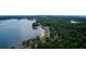 Stunning aerial view of the lake community, highlighting the beach, parking, and surrounding natural beauty at 535 Shamrock Dr, Cumming, GA 30040