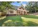 Expansive backyard features a covered patio and lush green lawn for outdoor entertaining and relaxation at 535 Shamrock Dr, Cumming, GA 30040