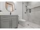 Modern bathroom with glass shower, stone counters, and gray vanity at 535 Shamrock Dr, Cumming, GA 30040