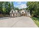 New construction home with a large driveway, lawn, and professionally designed exterior at 535 Shamrock Dr, Cumming, GA 30040