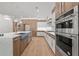 Spacious kitchen with stainless appliances, center island, and custom lighting at 535 Shamrock Dr, Cumming, GA 30040