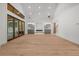 Bright living room with hardwood floors, built-in shelving, and oversized doors to backyard at 535 Shamrock Dr, Cumming, GA 30040