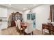 Formal dining room with backyard view, hardwood floors, and a decorative china cabinet at 537 Daffodil Ln, Mcdonough, GA 30253