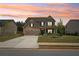 Lovely home showcases manicured lawn, long driveway and inviting sunset at 537 Daffodil Ln, Mcdonough, GA 30253