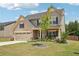 Two-story home features neutral siding, dark shutters and inviting front yard at 537 Daffodil Ln, Mcdonough, GA 30253
