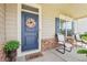 Welcoming front porch showcases a wreath, chairs, and natural lighting at 537 Daffodil Ln, Mcdonough, GA 30253