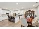 Modern kitchen and dining area with granite counters, white cabinets, hardwood floors, and bar seating at 537 Daffodil Ln, Mcdonough, GA 30253