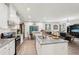 Open-concept kitchen with granite counters, hardwood floors, stainless appliances and a breakfast bar at 537 Daffodil Ln, Mcdonough, GA 30253