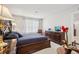 This main bedroom features a luxurious bed, a dresser, and soft, natural light at 537 Daffodil Ln, Mcdonough, GA 30253