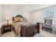This main bedroom features a luxurious bed, two side tables and soft, natural light at 537 Daffodil Ln, Mcdonough, GA 30253