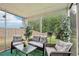 Relaxing screened porch with comfortable seating and a view of the backyard at 537 Daffodil Ln, Mcdonough, GA 30253