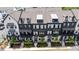 Aerial view of modern black and white townhomes with lush landscaping at 933 Catamaran Ct, Alpharetta, GA 30005