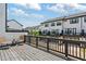 Townhome backyard with deck, chairs, and black metal railing at 933 Catamaran Ct, Alpharetta, GA 30005