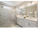 Bathroom featuring double sinks, a glass-enclosed shower with marble tile, and modern fixtures at 933 Catamaran Ct, Alpharetta, GA 30005