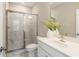Well-lit bathroom featuring a glass-enclosed shower with marble tile and a modern vanity with stylish fixtures at 933 Catamaran Ct, Alpharetta, GA 30005