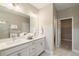 Bathroom vanity featuring double sinks, and modern fixtures with access to the shower and walk-in closet at 933 Catamaran Ct, Alpharetta, GA 30005