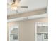 Bedroom featuring a tray ceiling, fan and multiple windows at 933 Catamaran Ct, Alpharetta, GA 30005