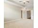 Spacious bedroom with neutral carpet, tray ceiling and multiple doorways at 933 Catamaran Ct, Alpharetta, GA 30005