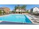 Community pool surrounded by lounge chairs and a covered pavilion at 933 Catamaran Ct, Alpharetta, GA 30005