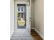 Inviting entryway with hardwood floors and a view of the charming home exterior through the open front door at 933 Catamaran Ct, Alpharetta, GA 30005