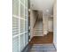 Welcoming entryway with hardwood floors, staircase with wooden banister, and a view into the home's layout at 933 Catamaran Ct, Alpharetta, GA 30005