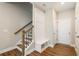 Stylish entryway featuring a staircase, built-in bench with storage, and coat hooks, perfect for organization at 933 Catamaran Ct, Alpharetta, GA 30005