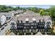Stylish townhome with eye-catching black and white exterior, dormer windows, and covered front porches at 933 Catamaran Ct, Alpharetta, GA 30005