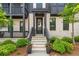 Inviting home exterior showcasing a brick facade, landscaped front yard, and a charming entryway with decorative plants at 933 Catamaran Ct, Alpharetta, GA 30005