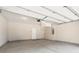 Clean garage featuring an automatic door, ample space, and a convenient access door to the home's interior at 933 Catamaran Ct, Alpharetta, GA 30005