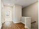 Upstairs hallway with hardwood floors and natural light from the window at 933 Catamaran Ct, Alpharetta, GA 30005