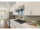 The kitchen features sleek stainless steel appliances and a modern backsplash at 933 Catamaran Ct, Alpharetta, GA 30005
