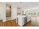 Kitchen island with stainless steel appliances, white cabinetry, and pendant lighting at 933 Catamaran Ct, Alpharetta, GA 30005