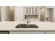 Bright kitchen with custom cabinets, quartz countertops, and stainless steel appliances at 933 Catamaran Ct, Alpharetta, GA 30005