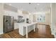 Modern kitchen with stainless steel appliances, white cabinets, and large island at 933 Catamaran Ct, Alpharetta, GA 30005