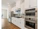 The kitchen features stainless steel appliances, stylish backsplash, and ample storage at 933 Catamaran Ct, Alpharetta, GA 30005