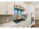 Modern kitchen with stainless steel appliances, quartz countertops, and stylish backsplash at 933 Catamaran Ct, Alpharetta, GA 30005