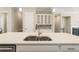 Features a custom butlers pantry, quartz countertops, and stainless appliances at 933 Catamaran Ct, Alpharetta, GA 30005