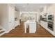 Open kitchen featuring white cabinets, stainless appliances, and a large center island at 933 Catamaran Ct, Alpharetta, GA 30005