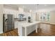 Contemporary kitchen featuring a large island, stainless appliances, and white cabinetry at 933 Catamaran Ct, Alpharetta, GA 30005