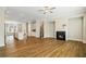 Open-concept living space with fireplace, kitchen, wood floors, and recessed lights at 933 Catamaran Ct, Alpharetta, GA 30005