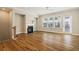 Bright living room with fireplace, wood floors, and natural light from large windows at 933 Catamaran Ct, Alpharetta, GA 30005